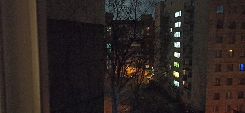 A shot from a window with a view of multi-storey residential buildings in the surrounding area.