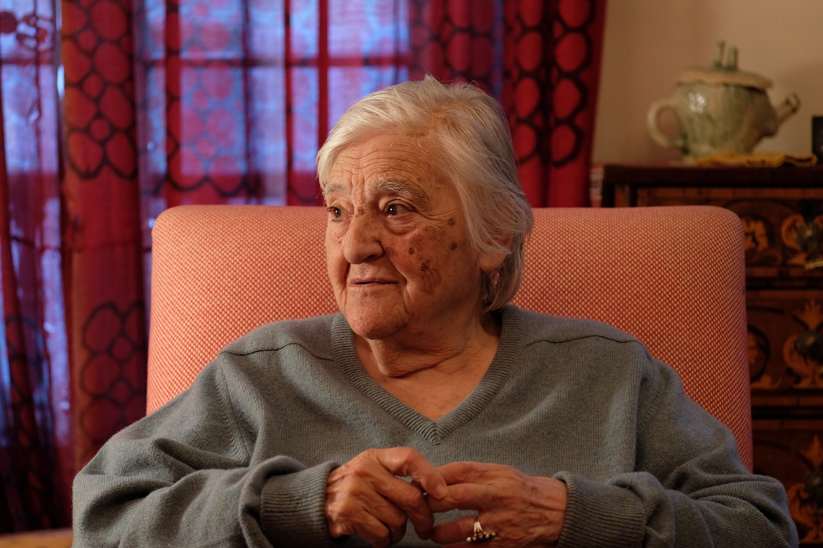 Etel Adnan sitzt in einem Sessel und schaut zur Seite