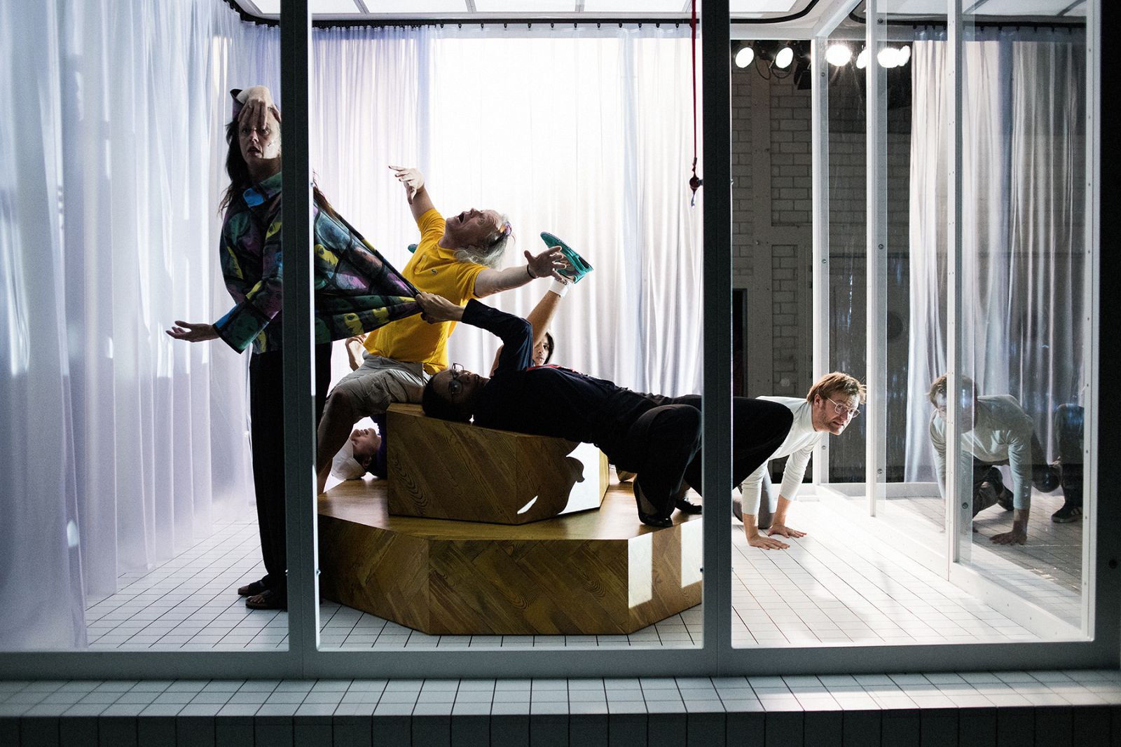 People in various contortions on a pedestal