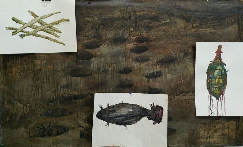 three painted sheets lying on a large painting.