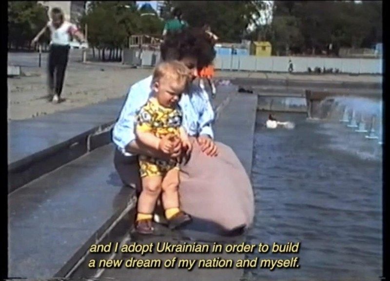 A woman and a child in front of a well.